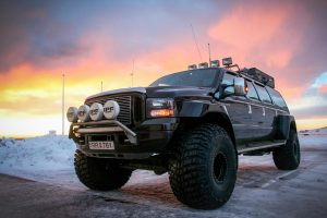 Super Jeep are waiting in the sunset on a tour in Iceland