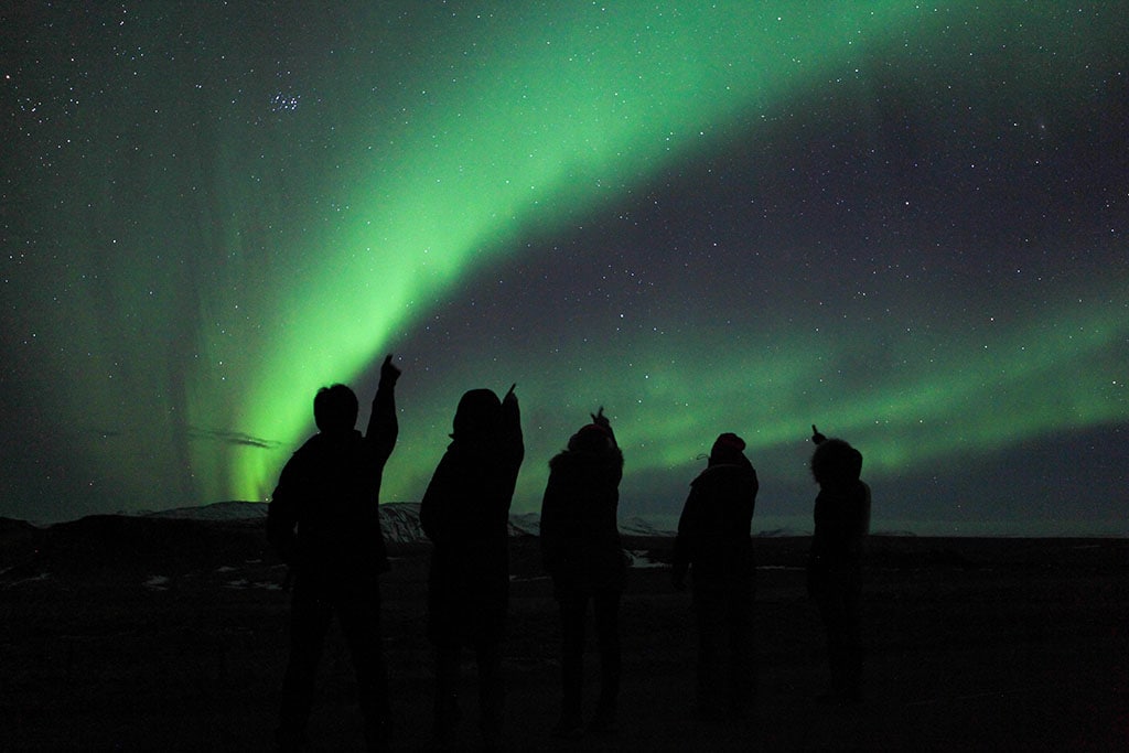 Visitors watching the Northern Lights in Iceland