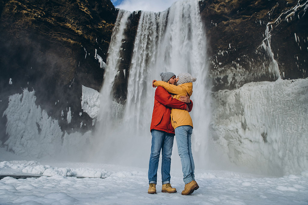 Couple at the Skogafoss waterfall in Iceland