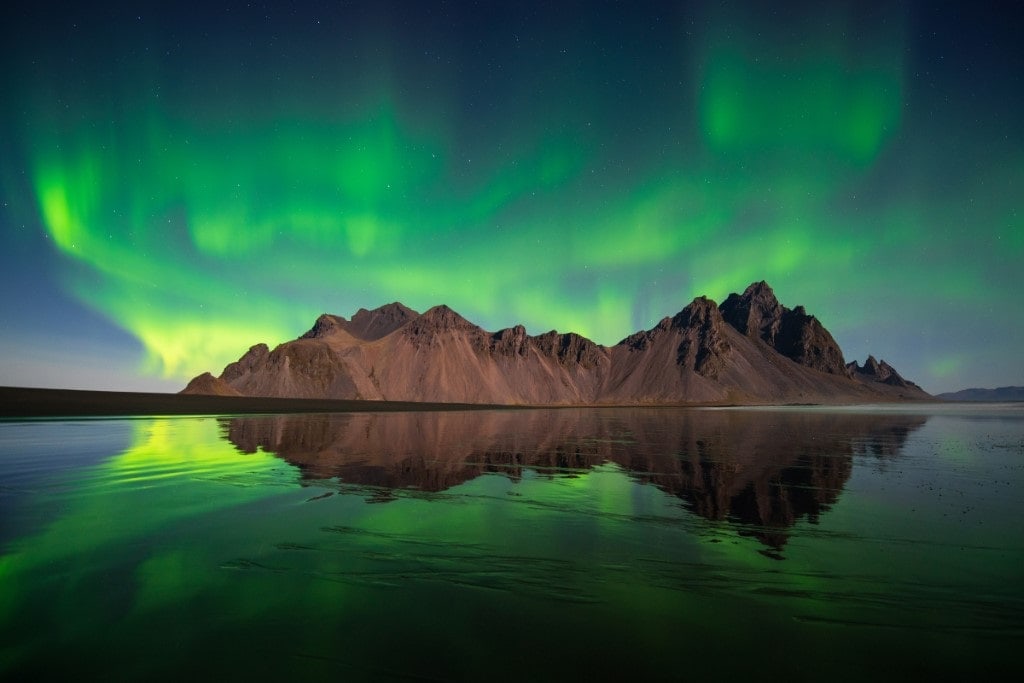 The mountains at Stokksnes and the sea make a perfect foreground for a perfect Northern Lights photo