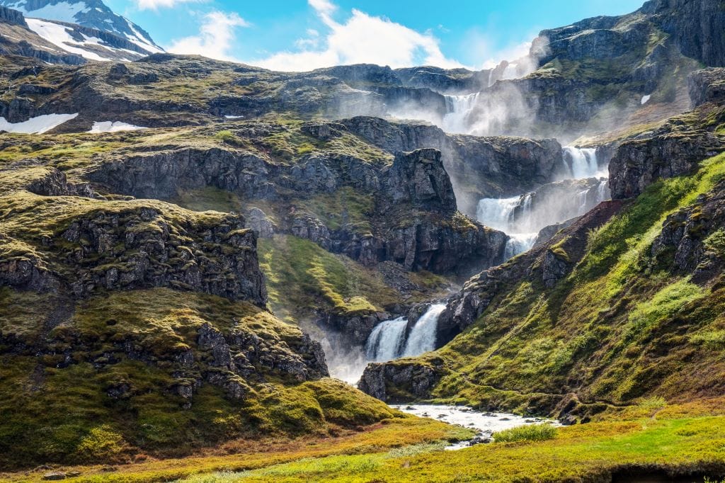 Klifbrekkufossar waterfall in vibrant green settings in East Icealnd