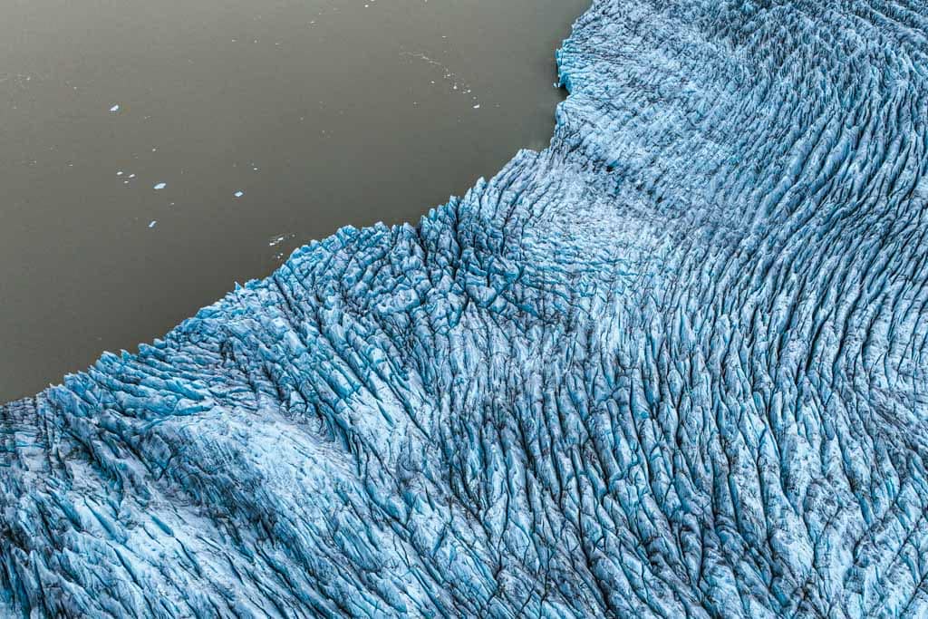 Aerial view of a glacier as it meets the water