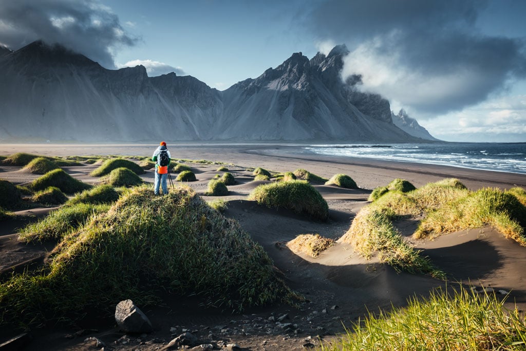 Unique view on green hills with sand dunes. Location Stokksnes cape, Vestrahorn (Batman Mount), Iceland, Europe. Scenic image of tourist attraction. Travel destination. Discover the beauty of earth.