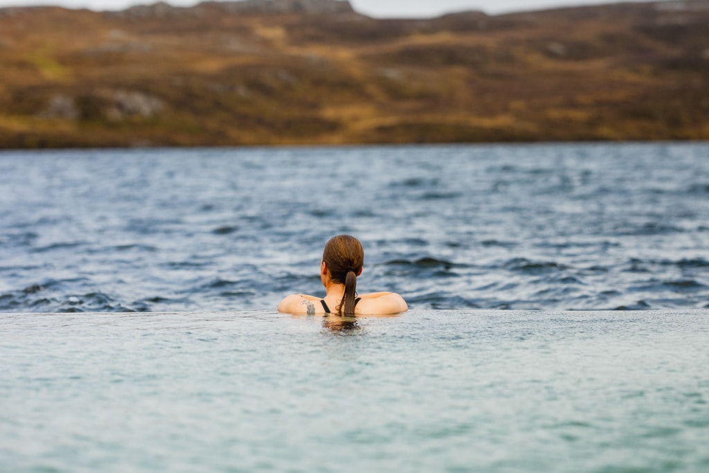 Woman enjoying the view from Vök Baths East Iceland