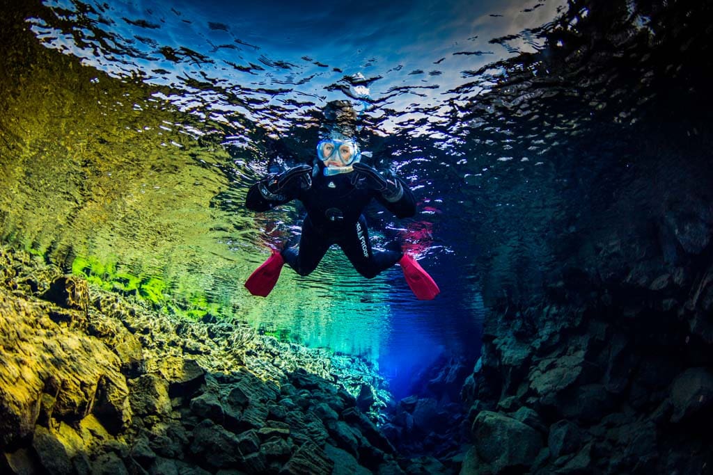 Woman snorkeling between the tectonic plates