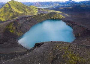 Ljótipollur crater lake with vivid turquoise water surrounded by rugged volcanic terrain, showcasing Iceland hidden gems.