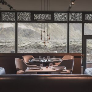 Restaurant with large windows offering a view of Iceland’s rugged landscape. Ideal for a fine dining experience.