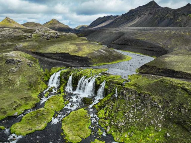 Green valleys and cascading waterfalls in the highlands on the Iceland Highlands Super Jeep Tour.
