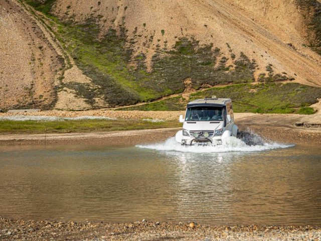 Superjeep splashing through a river crossing in the Iceland Highlands on a Landmannalaugar tour.