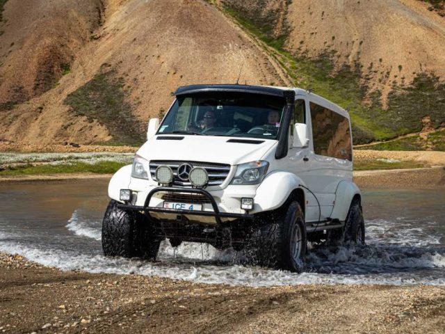 White superjeep exiting a river crossing in the Iceland Highlands on a Landmannalaugar tour.