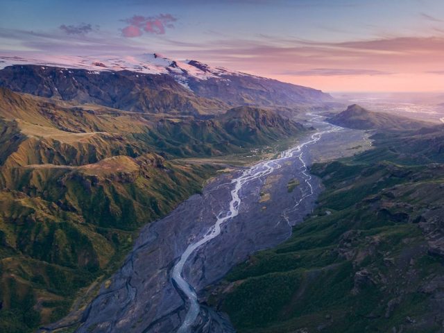 Aerial view of a river snaking through a valley at sunset in Thórsmörk.