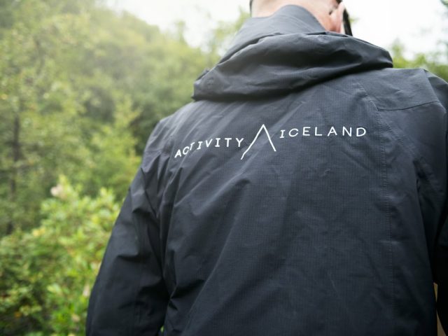 Close-up of a person wearing a jacket with "Activity Iceland" logo in Thórsmörk.