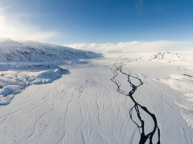 Exclusive view of a private luxury tour jeep overlooking a snowy Icelandic landscape, the Highlands of Iceland,