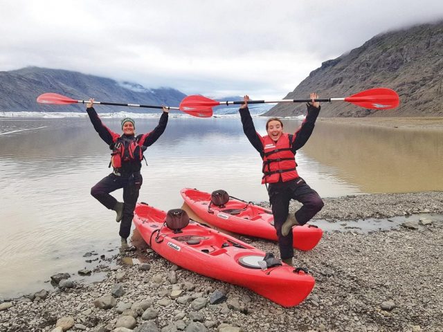 Two happy tourists kayaking in Icelancic glacier lagoon
